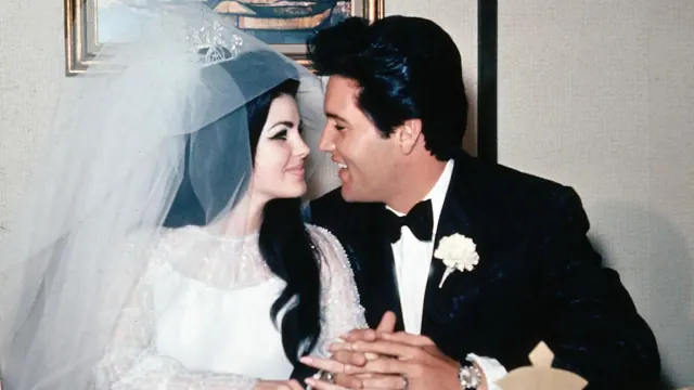 Priscilla and Elvis Presley together at their wedding reception
