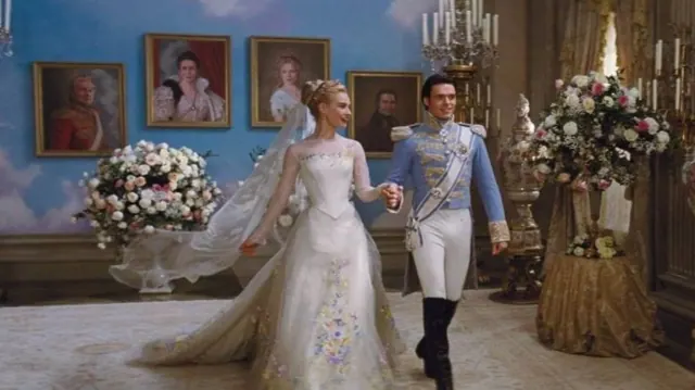 Lily James as Cinderella in a floral wedding gown beside Richard Madden's prince
