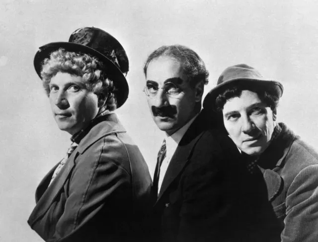 Three Marx brothers posing together in an older black-and-white publicity photograph