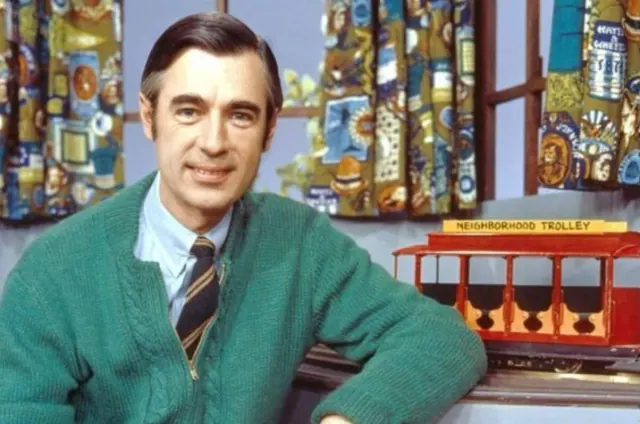 Fred Rogers beside the red Neighborhood Trolley