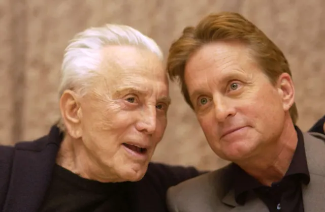 Kirk and Michael Douglas seated closely together in an older photograph