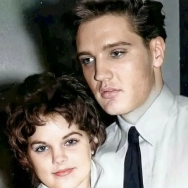 Priscilla standing beside Elvis in an early portrait