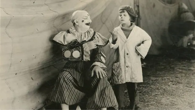 Child actor Jackie Coogan with a clown in a still from the 1923 movie “Circus Days.”