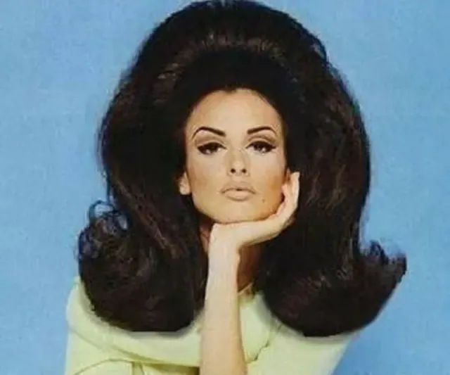 Portrait of Priscilla wearing a large dark bouffant