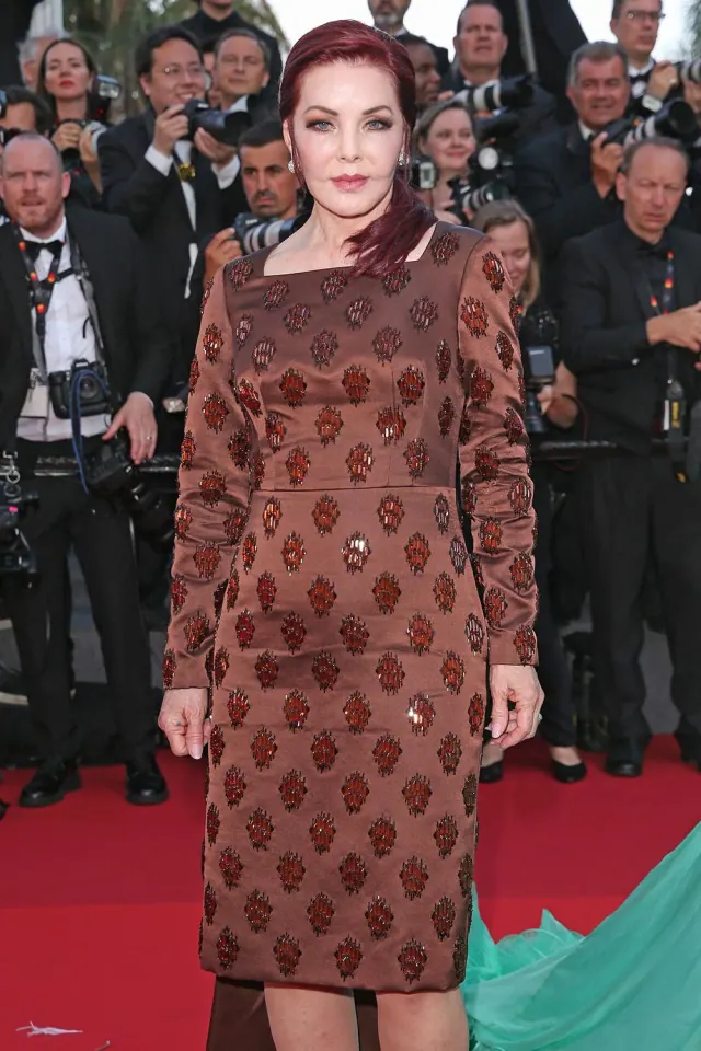 Priscilla wearing a patterned burgundy dress at the 2022 Cannes premiere