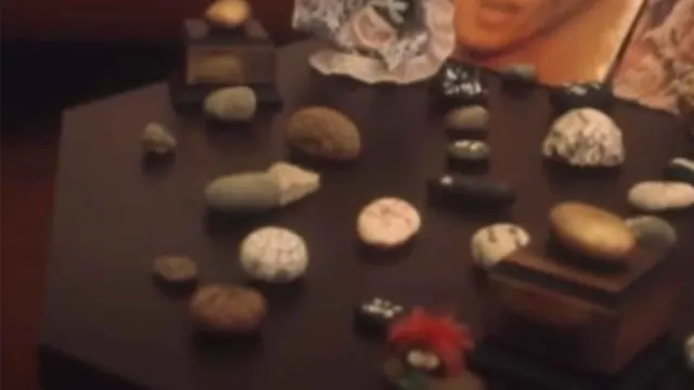 Assorted stones arranged on a table in archival video footage