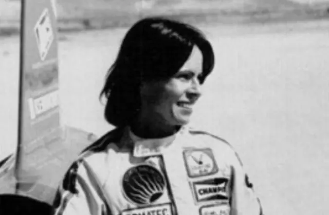Kitty O'Neil wearing a racing suit in a black-and-white archive portrait.