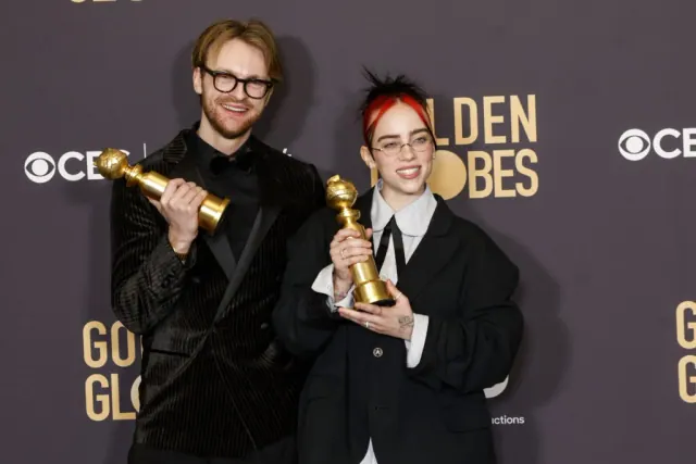 Finneas and Billie Eilish holding Golden Globe awards