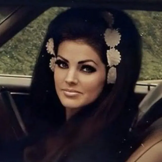 Close portrait of Priscilla with dark hair and defined eye makeup