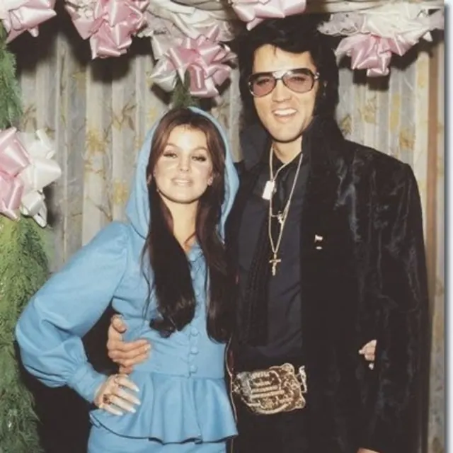 Priscilla and Elvis standing together in a family photograph