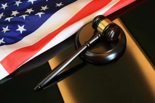 A gavel and U.S. flag used to illustrate the legal context