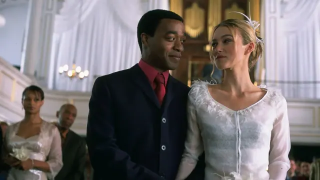 Keira Knightley as Juliet in a sheer bridal top beside Chiwetel Ejiofor as Peter