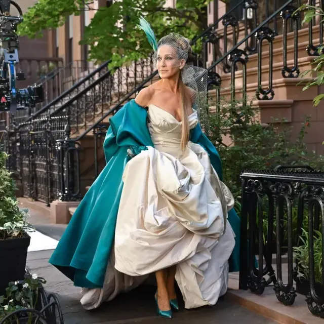 Sarah Jessica Parker as Carrie wearing a Vivienne Westwood bridal gown with teal gloves and wrap