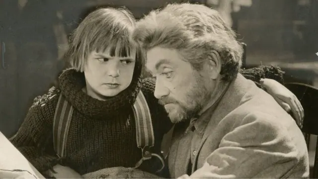 Child actor Jackie Coogan with an adult actor in movie still from 1925’s “The Rag Man.”