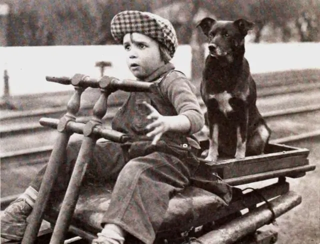 Jackie Coogan riding a wagon with a dog in an archive still from Peck's Bad Boy.