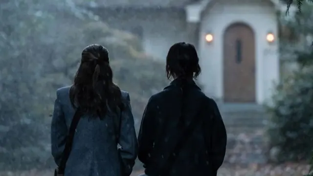 Sister Barnes (Sophie Thatcher) and Sister Paxton (Chloe East) standing in front of a house in