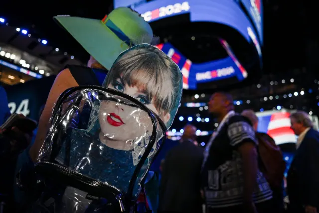 A DNC attendee with a Taylor Swift sign on a backpack in August 2024