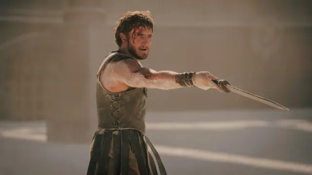 Lucius (Paul Mescal) stands with a sword pointed at an enemy in 'Gladiator II.'