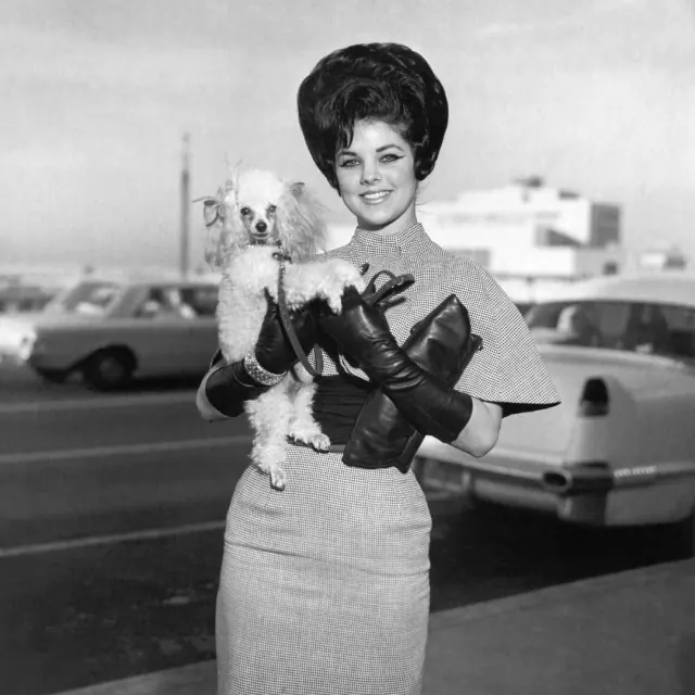 Black-and-white photograph of Priscilla standing outdoors