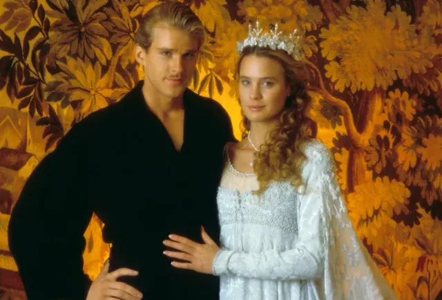 Robin Wright as Buttercup wearing a decorated pale gown and crown beside Cary Elwes