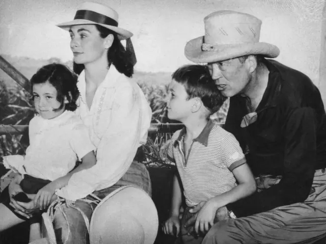 Older black-and-white Huston family photograph with two adults and two children