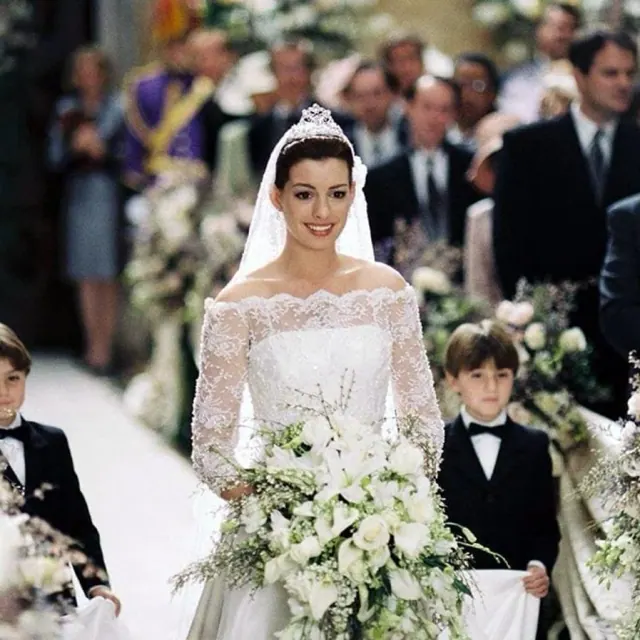 Anne Hathaway as Mia wearing a lace-sleeved bridal gown and tiara in The Princess Diaries 2