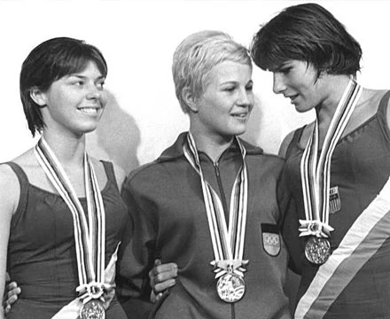 Olympic medalists in an archive photograph; not an image of O'Neil competing at the Olympics.