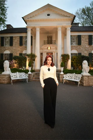 Priscilla standing in front of Graceland
