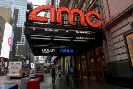 NEW YORK, NY - MAY 16: People walk past an AMC movie theater on 42nd Street in Times Square on May 16, 2024, in New York City.